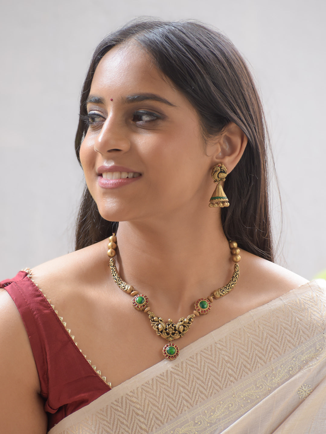 Sarangika - Handcrafted Terracotta Peacock Motif Necklace Set with Green Red Accents and Antique Gold Finish and Matching Earrings