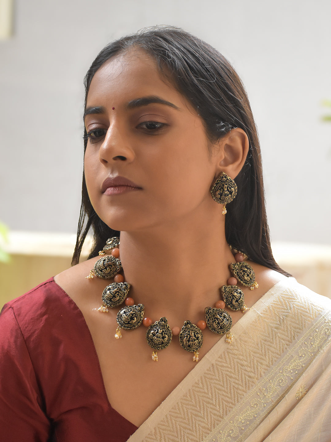 Handcrafted Terracotta Lakshmi Necklace Set with Antique Gold Finish, Orange Beads, and Pearl Danglers