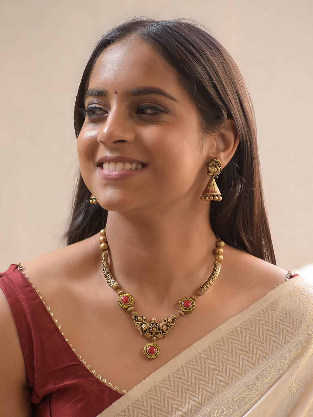 Mayuralika - Handcrafted Terracotta Peacock Motif Necklace Set with Red-Yellow Floral Accents and Antique Gold Beads and Matching Earrings