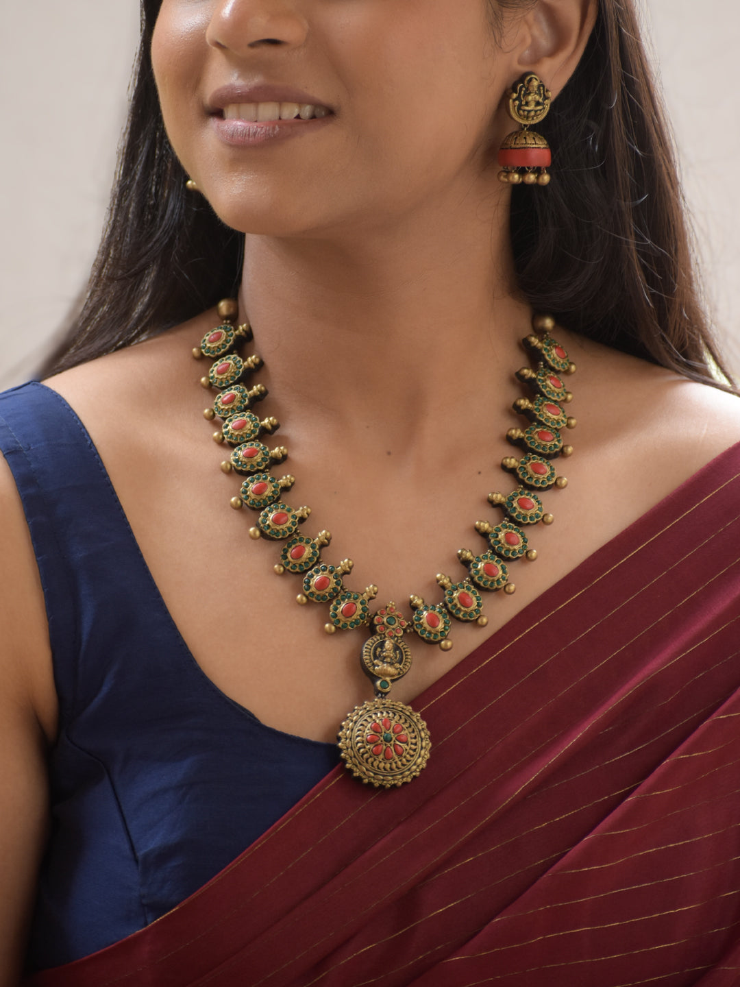 Lakshmira - Handmade Terracotta Lakshmi Pendant Necklace Set in Antique Gold with Red & Green Accents and Matching Earrings