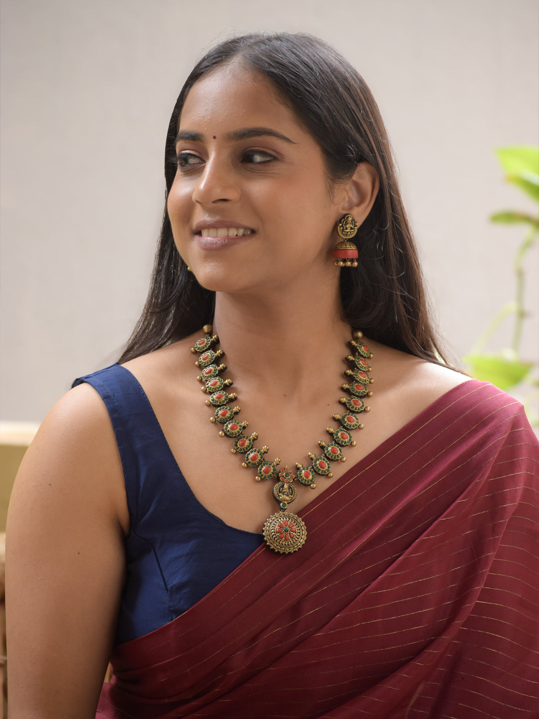 Lakshmira - Handmade Terracotta Lakshmi Pendant Necklace Set in Antique Gold with Red & Green Accents and Matching Earrings