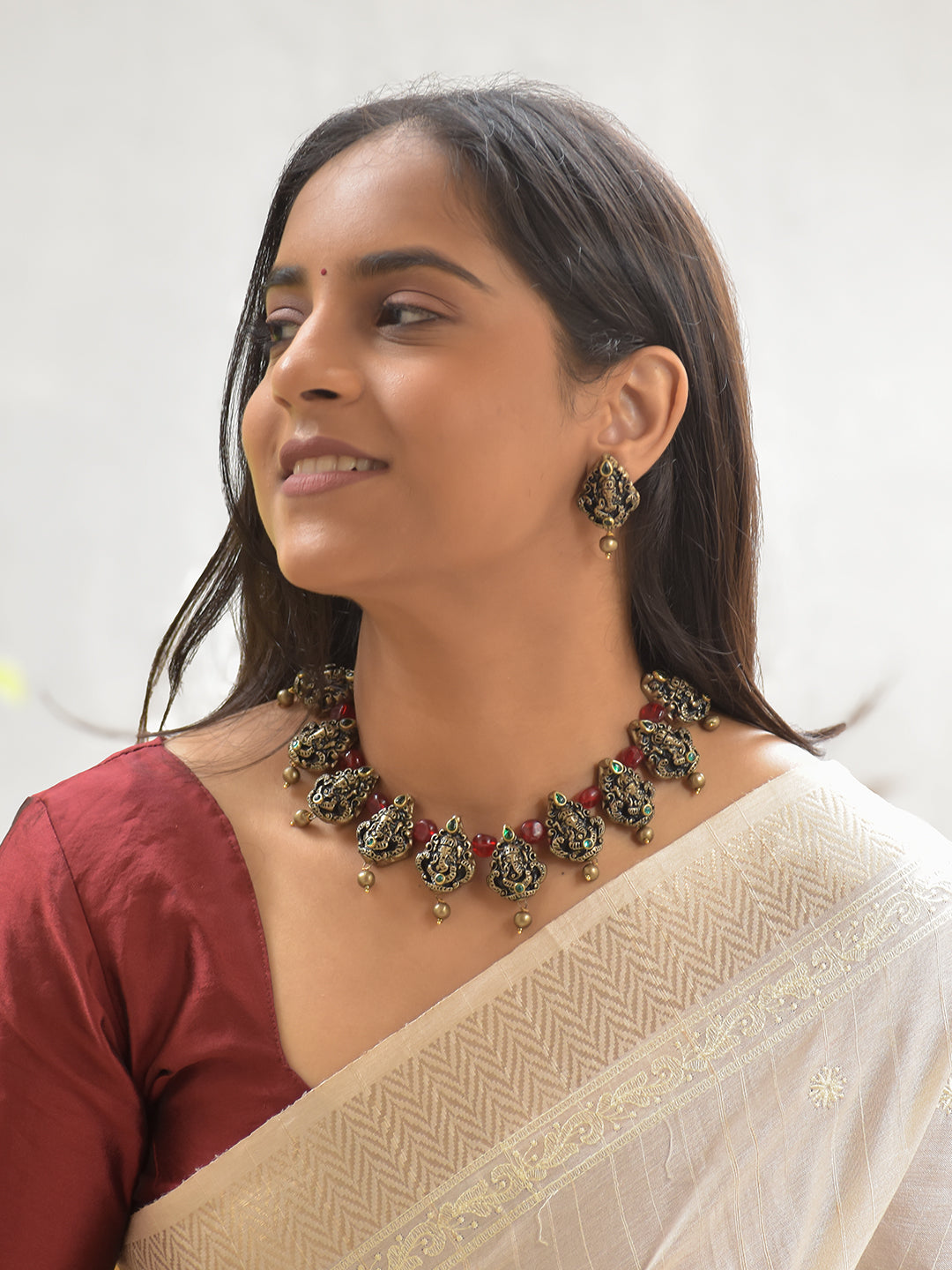 Handcrafted Terracotta Lord Ganesha Necklace Set with Antique Gold Finish, Red Beads, and Green Stone Accents