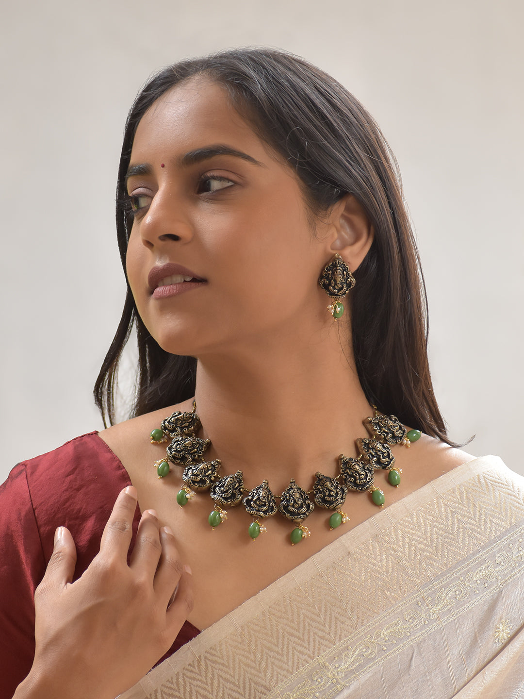 Handcrafted Terracotta Ganesha Necklace Set with Antique Gold Finish, Green Beads, and Matching Earrings