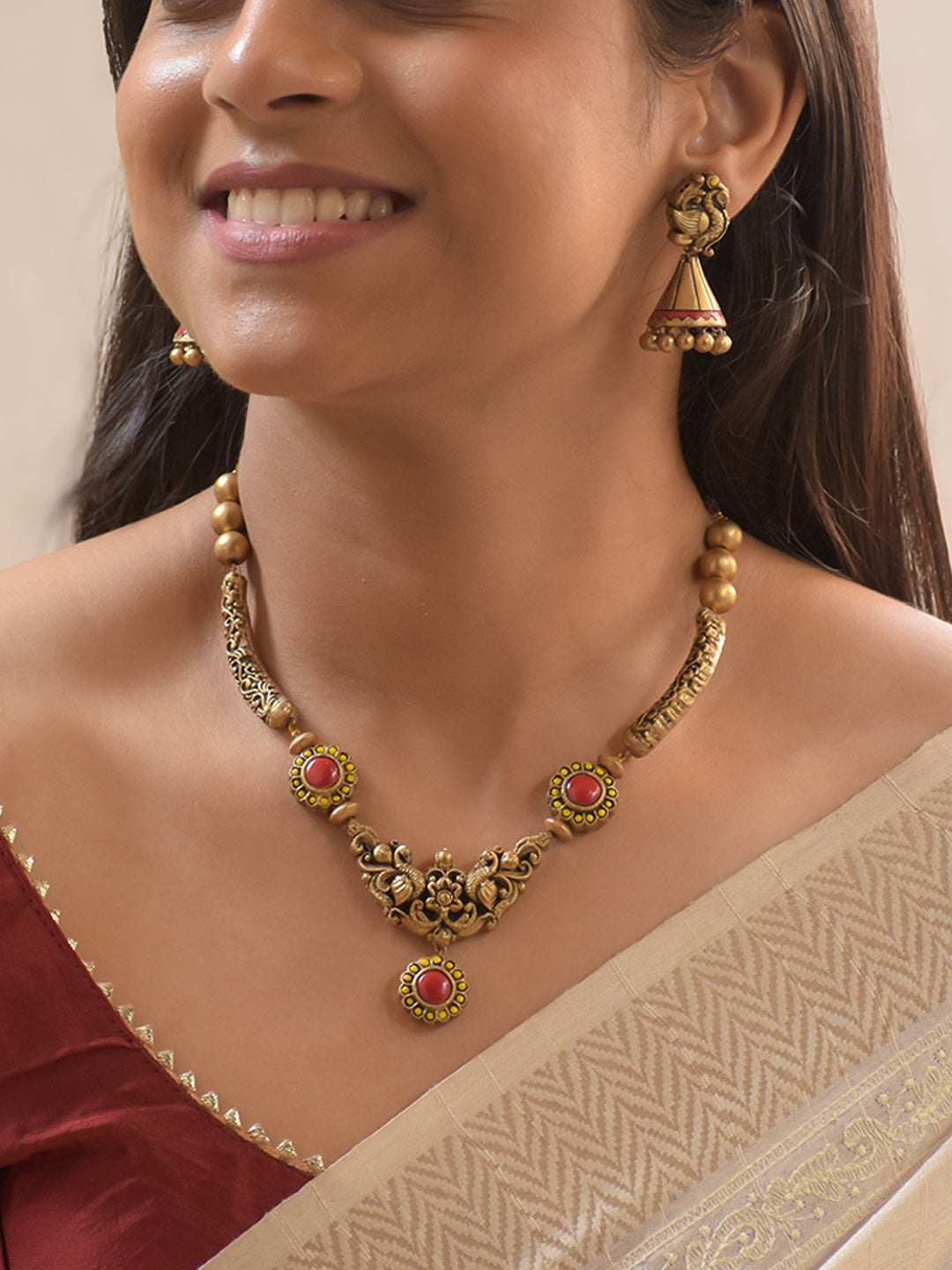 Mayuralika - Handcrafted Terracotta Peacock Motif Necklace Set with Red-Yellow Floral Accents and Antique Gold Beads and Matching Earrings