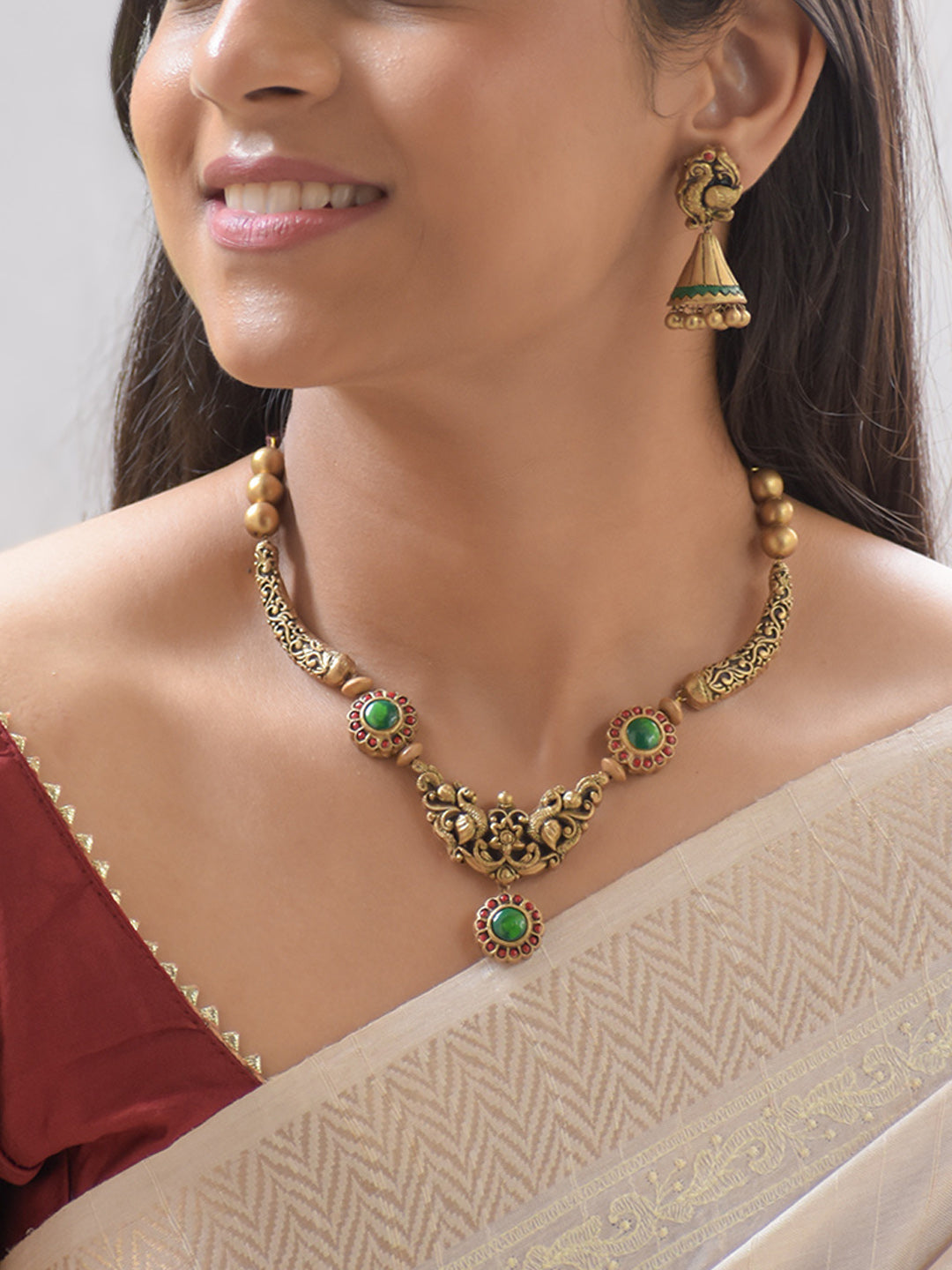 Sarangika - Handcrafted Terracotta Peacock Motif Necklace Set with Green Red Accents and Antique Gold Finish and Matching Earrings