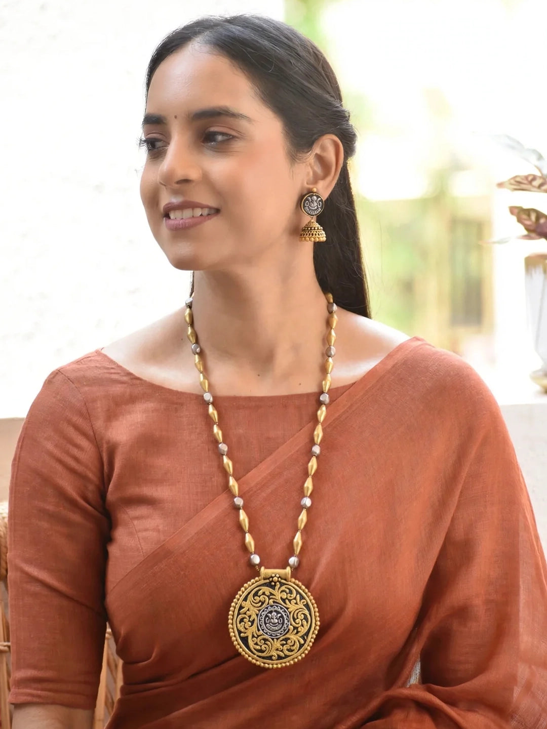 Handmade Terracotta Dual-Tone Round Ganesha Design Pendant Necklace with Antique Jhumka Earrings