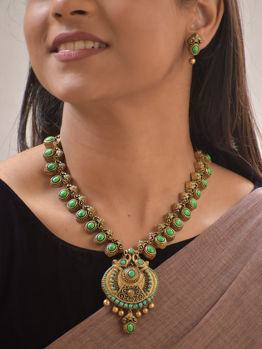 Vaidika – Terracotta Antique Gold and Green Stone Necklace Set with Temple Peacock Motif Pendant and Earrings